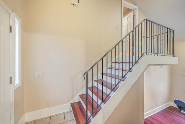 stairs featuring tile patterned floors