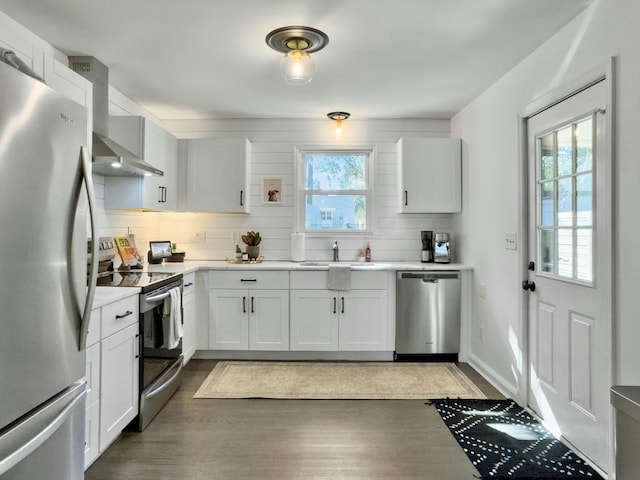 kitchen featuring plenty of natural light, appliances with stainless steel finishes, white cabinets, and light countertops