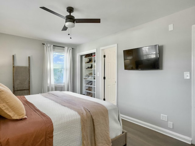 bedroom featuring ceiling fan, dark wood finished floors, and baseboards