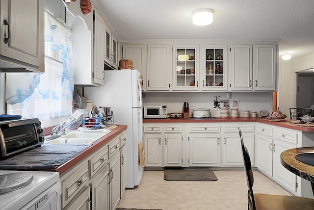 2363 Ranger Dr, Cross, SC 29436 - kitchen with white appliances, a sink, glass insert cabinets, and white cabinets