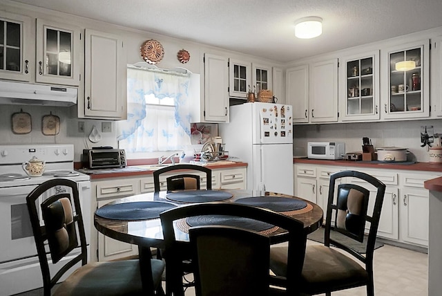 2363 Ranger Dr, Cross, SC 29436 - kitchen featuring white appliances, under cabinet range hood, glass insert cabinets, white cabinetry, and light countertops