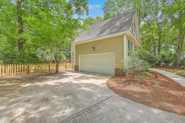 2028 Prospect Hill Dr, Mount Pleasant, SC 29464 - view of side of property featuring a garage, driveway, and a shingled roof