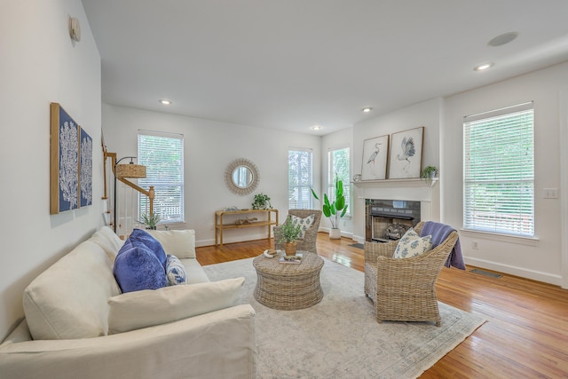2028 Prospect Hill Dr, Mount Pleasant, SC 29464 - living room featuring a tile fireplace, baseboards, plenty of natural light, light wood-style floors, and recessed lighting