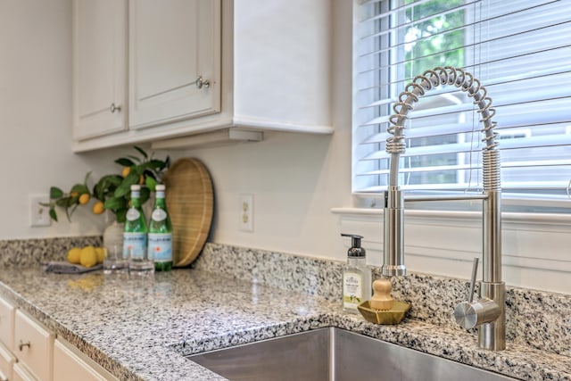 2028 Prospect Hill Dr, Mount Pleasant, SC 29464 - kitchen view of a sink, white cabinetry, and light stone counters