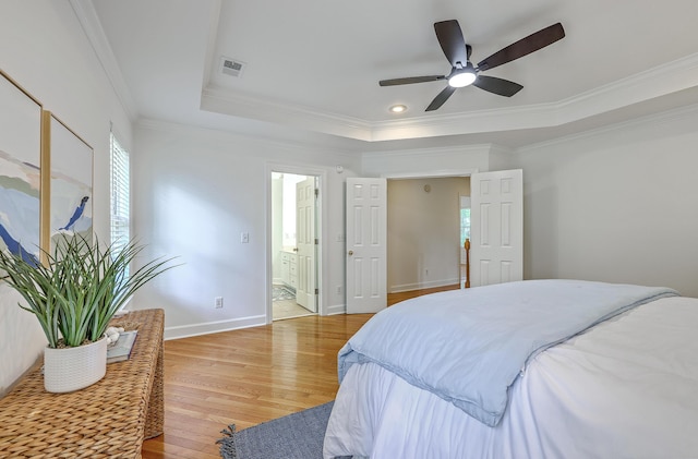 2028 Prospect Hill Dr, Mount Pleasant, SC 29464 - bedroom with multiple windows, light wood finished floors, ornamental molding, a tray ceiling, and ensuite bathroom