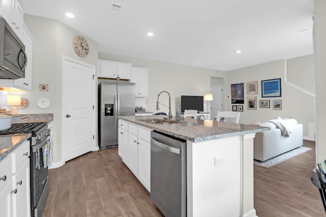 725 Pepperbush St, Charleston, SC 29414 - kitchen featuring appliances with stainless steel finishes, a sink, wood finished floors, light stone countertops, and recessed lighting