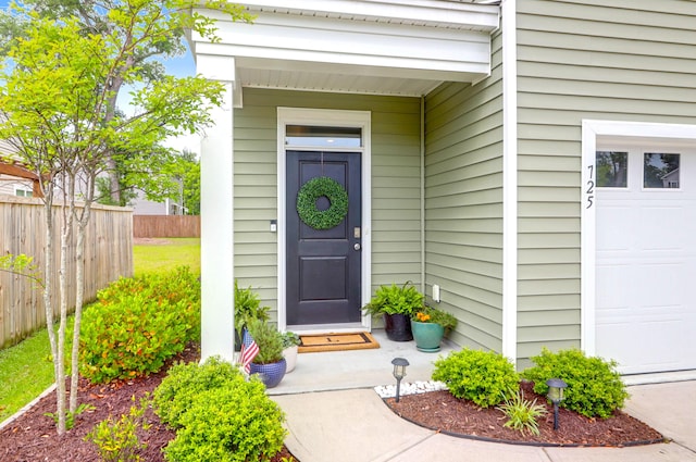 725 Pepperbush St, Charleston, SC 29414 - view of exterior entry featuring fence and a garage