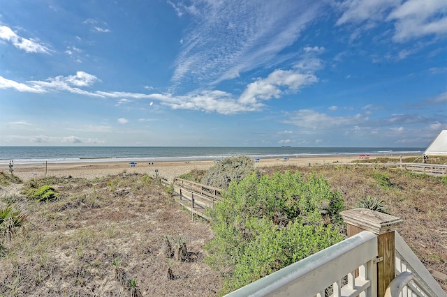 water view featuring fence and a view of the beach