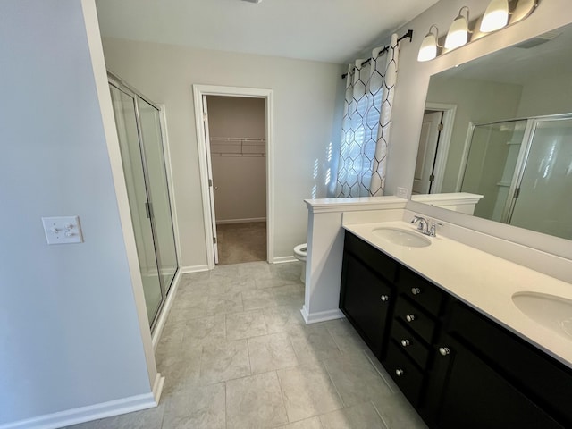 bathroom featuring walk in shower, vanity, and toilet