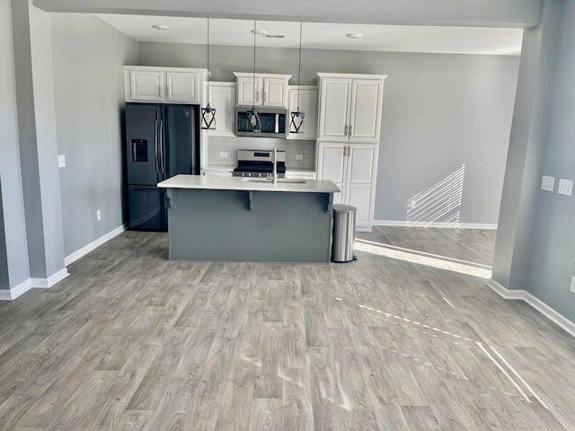 515 Purple Finch Rd, Summerville, SC 29486 - kitchen with light wood-style floors, white cabinetry, stainless steel appliances, and light countertops