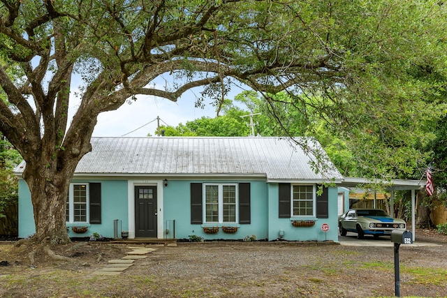 532 Sunset Dr, Charleston, SC 29407 - ranch-style house featuring stucco siding, an attached carport, metal roof, and dirt driveway