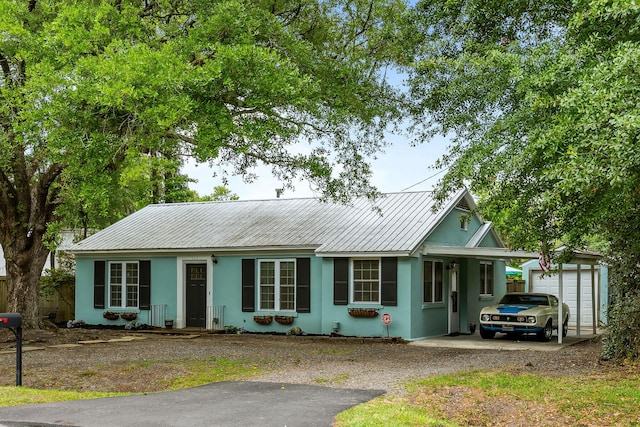 532 Sunset Dr, Charleston, SC 29407 - ranch-style home featuring stucco siding, metal roof, driveway, and an outbuilding