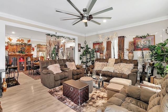 living room with crown molding, ceiling fan, and light wood-type flooring