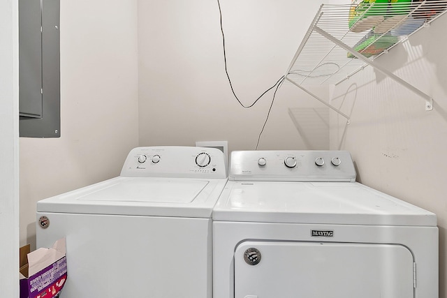 laundry room with washing machine and clothes dryer and electric panel