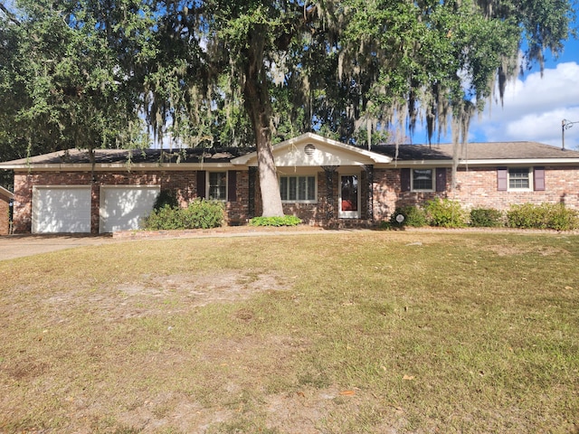 ranch-style house featuring a front lawn and a garage