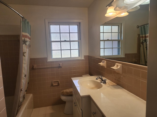 full bathroom with shower / bath combo, toilet, tile walls, vanity, and tile patterned flooring