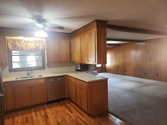 kitchen featuring light hardwood / wood-style floors, kitchen peninsula, dishwasher, and sink