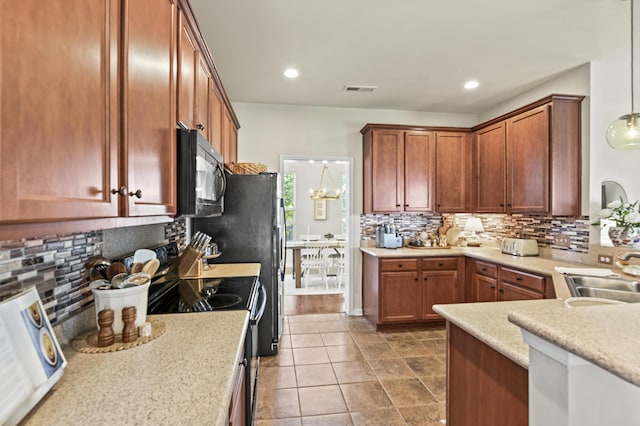 243 Old Savannah Dr, Goose Creek, SC 29445 - kitchen with black microwave, a sink, backsplash, brown cabinets, and recessed lighting