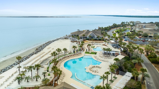 drone / aerial view featuring a beach view and a water view