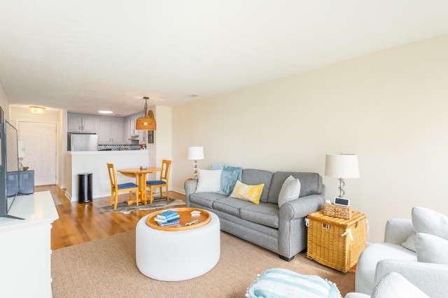 living room featuring light wood finished floors and baseboards