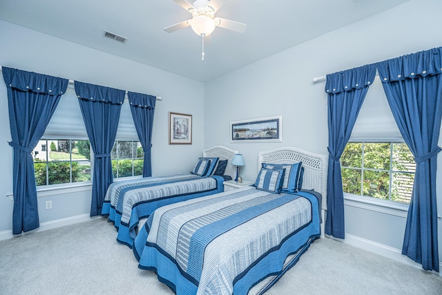 2418 Tuscany Dr, North Charleston, SC 29406 - carpeted bedroom featuring visible vents, baseboards, ceiling fan, and multiple windows