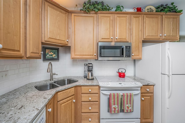 2418 Tuscany Dr, North Charleston, SC 29406 - kitchen with white appliances, light stone counters, decorative backsplash, and a sink