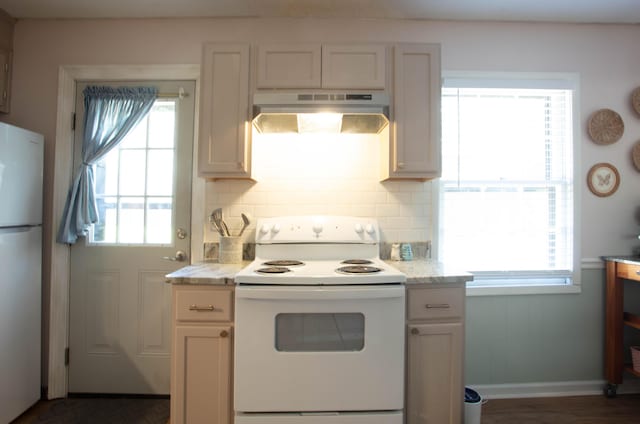 208 Owens Dr, Summerville, SC 29485 - kitchen with under cabinet range hood, white appliances, light stone counters, and decorative backsplash