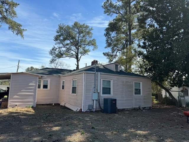 rear view of property featuring cooling unit