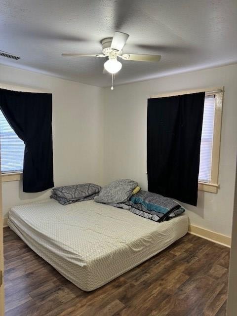 bedroom featuring ceiling fan and dark hardwood / wood-style floors