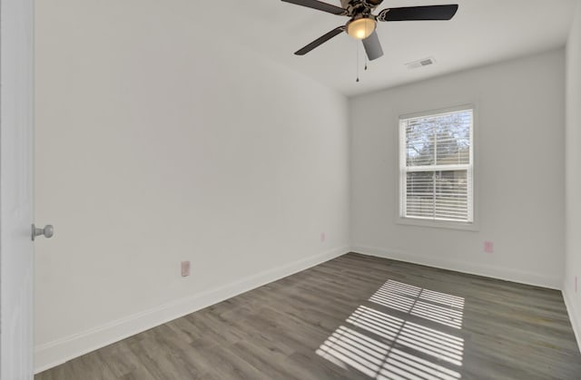 spare room featuring dark hardwood / wood-style floors and ceiling fan