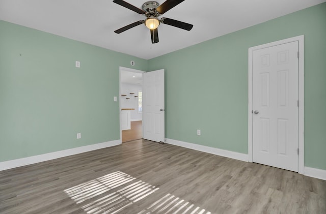 unfurnished bedroom with ceiling fan and light hardwood / wood-style flooring