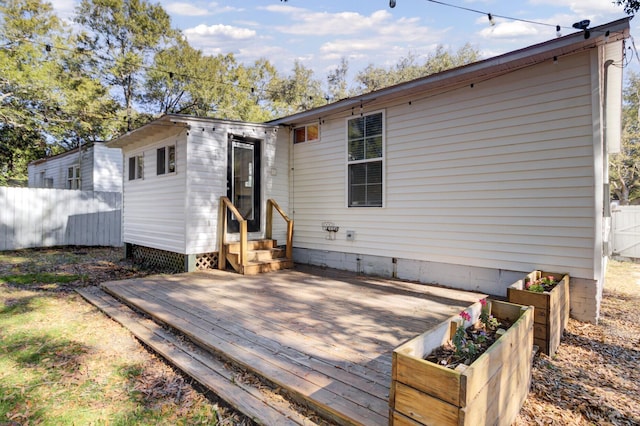 back of property featuring a wooden deck