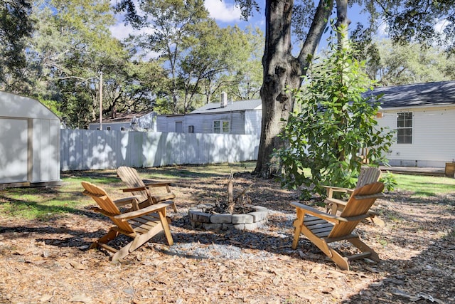 view of yard with a fire pit and a storage unit