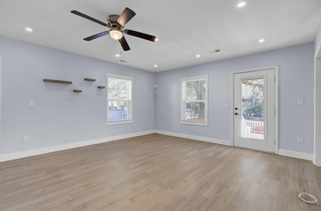 spare room with ceiling fan, light hardwood / wood-style flooring, and a wealth of natural light