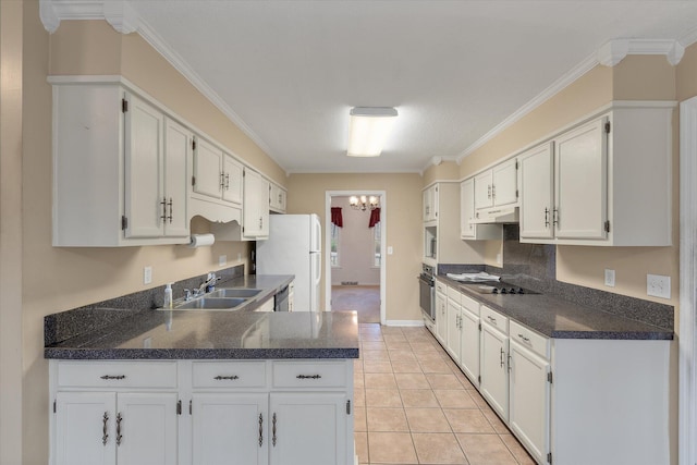 kitchen featuring freestanding refrigerator, crown molding, oven, and a sink