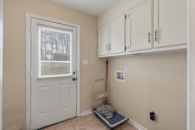 laundry area featuring washer hookup, light tile patterned flooring, cabinet space, and baseboards