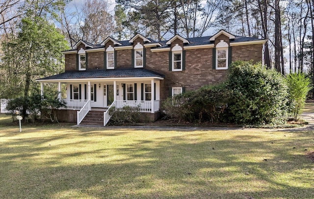 view of front facade featuring a front lawn, a porch, and brick siding