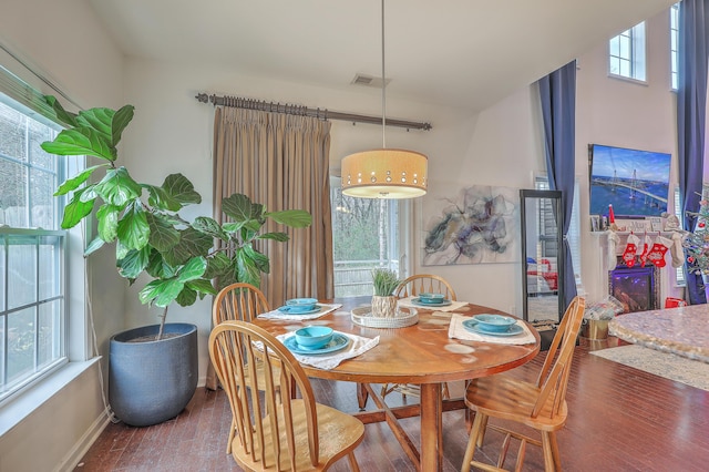 dining room with wood finished floors, visible vents, and baseboards