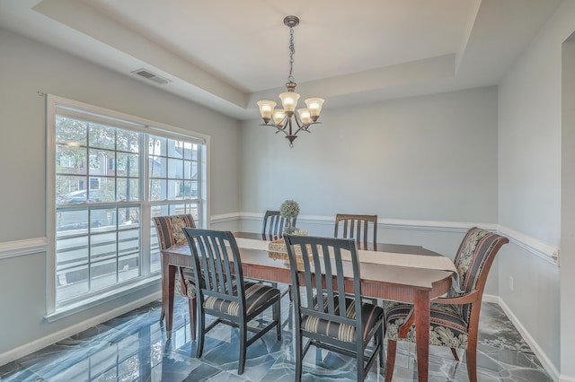 dining space featuring visible vents, baseboards, a notable chandelier, marble finish floor, and a raised ceiling