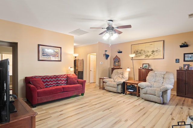 living room with a ceiling fan, light wood-type flooring, visible vents, and baseboards