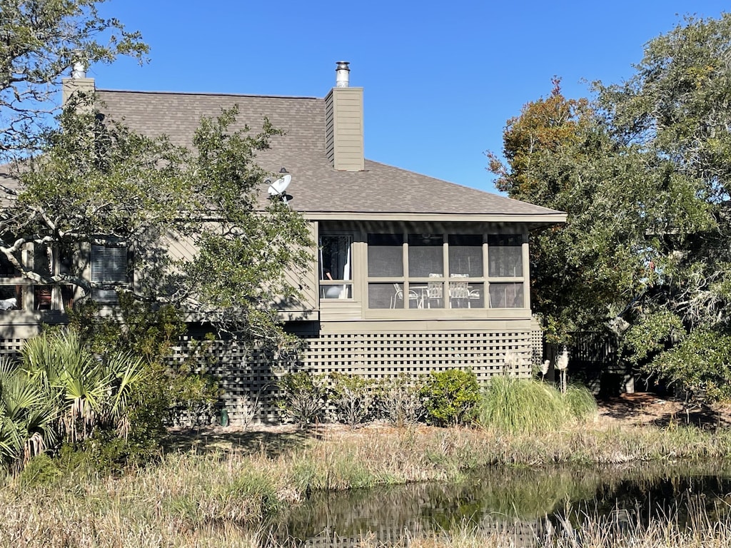 rear view of property featuring a sunroom