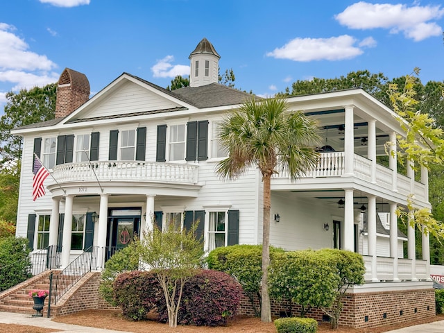 view of front of home featuring a balcony, ceiling fan, and covered porch