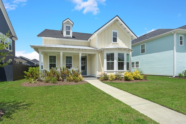 view of front of house with a front yard and a porch