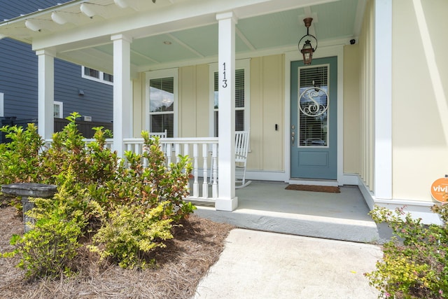 view of exterior entry with covered porch