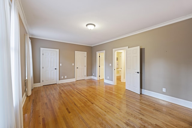 unfurnished bedroom featuring crown molding and light wood-type flooring