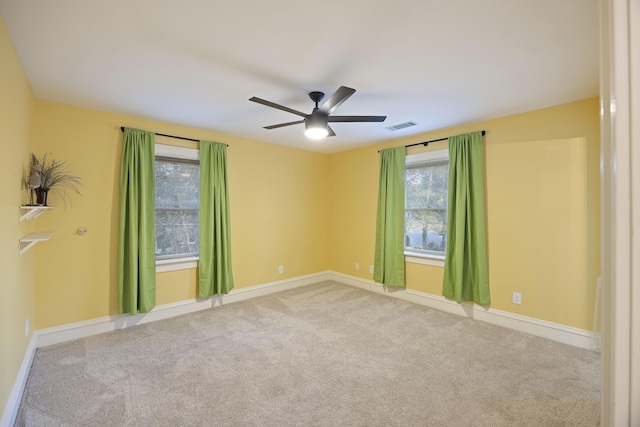 carpeted empty room featuring ceiling fan