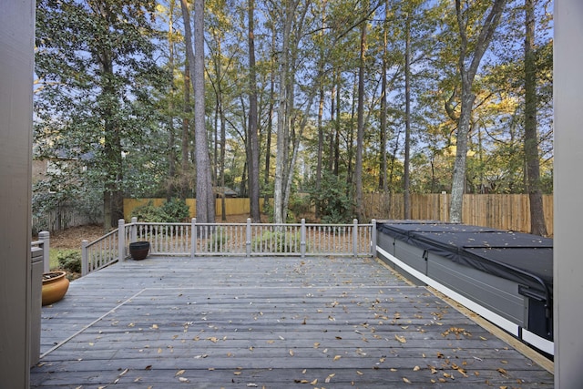 wooden terrace featuring a hot tub