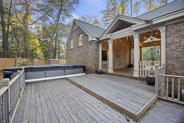 wooden deck featuring a hot tub