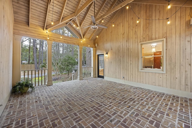 unfurnished sunroom featuring lofted ceiling with beams, ceiling fan, and wooden ceiling