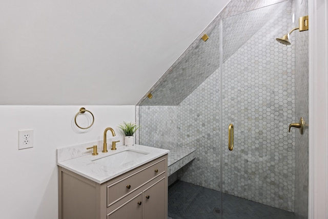 bathroom with vaulted ceiling, vanity, and an enclosed shower